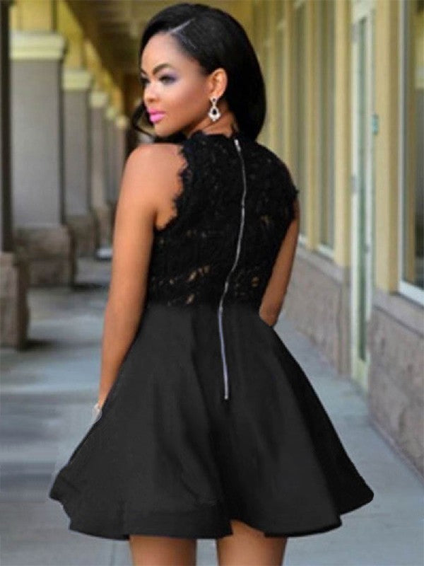 Close-up of the lace and satin fabric details on a black A-line short dress.