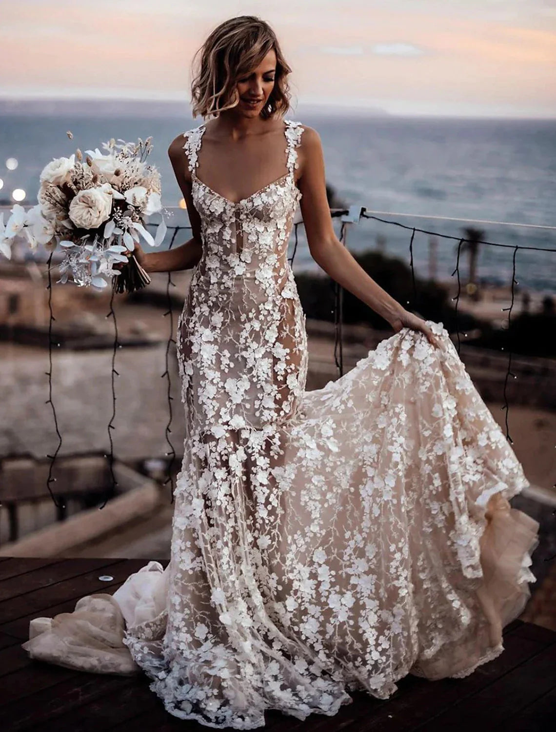 Detailed view of the court train and lace appliques on the back of the wedding dress.
