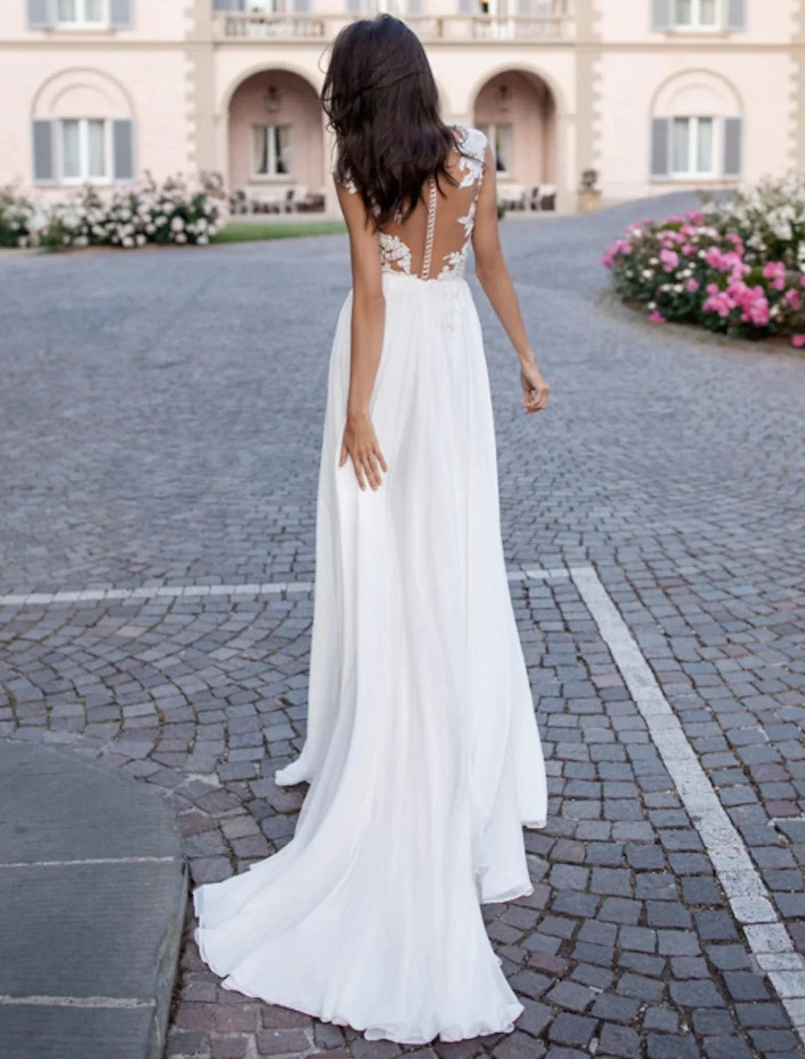 Back view of A-Line chiffon wedding dress showing open back and sweep train.