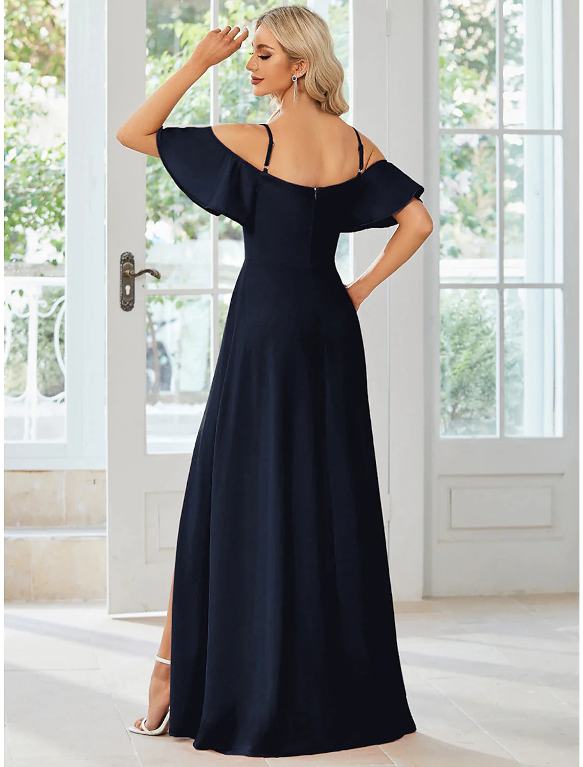 Full length view of the A-line dress, highlighting the slit and pure color.