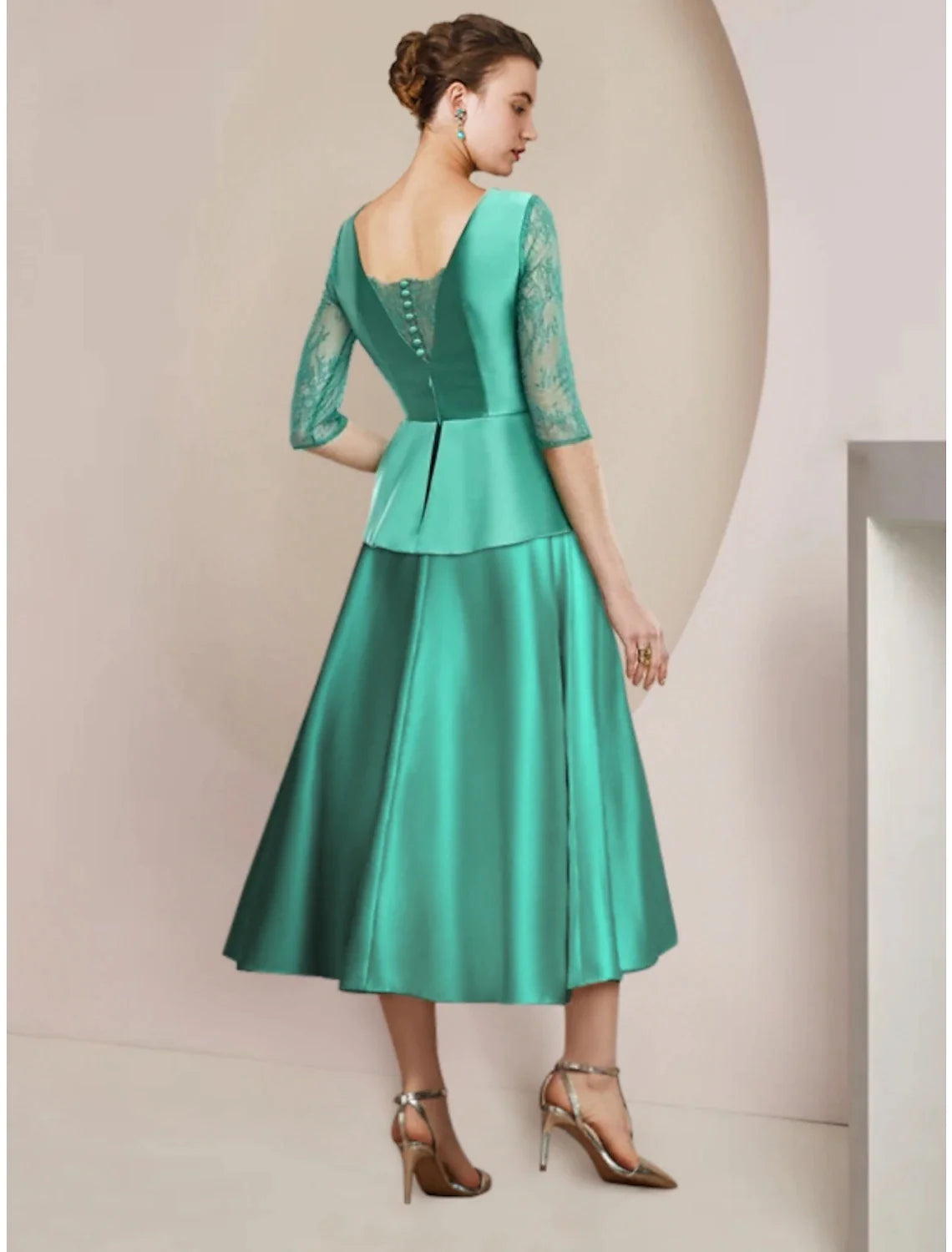 A-line tea-length dress with scoop neck, half sleeves, ruching, and bow detail, side view.