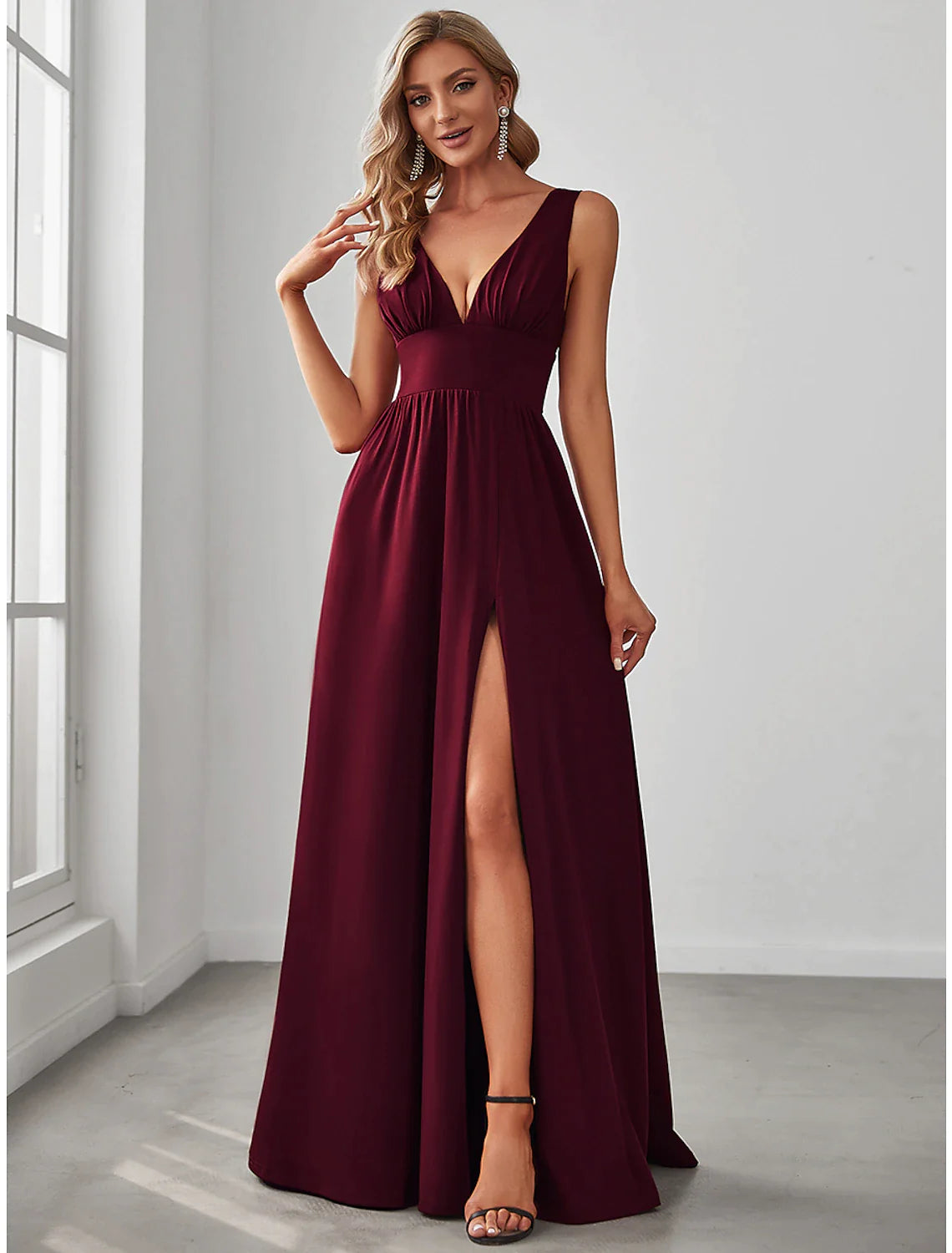 Woman in elegant light blue A-line V-neck chiffon dress with a high side split.