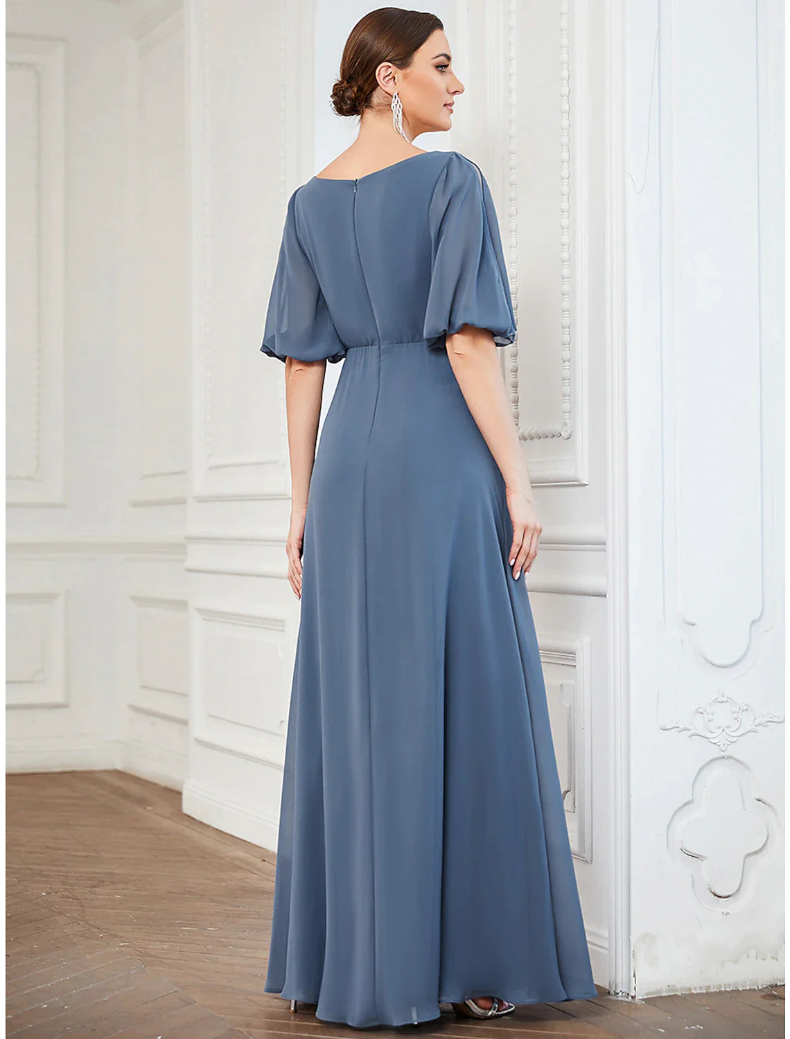 Full length view of a woman in a light blue A-line evening gown.
