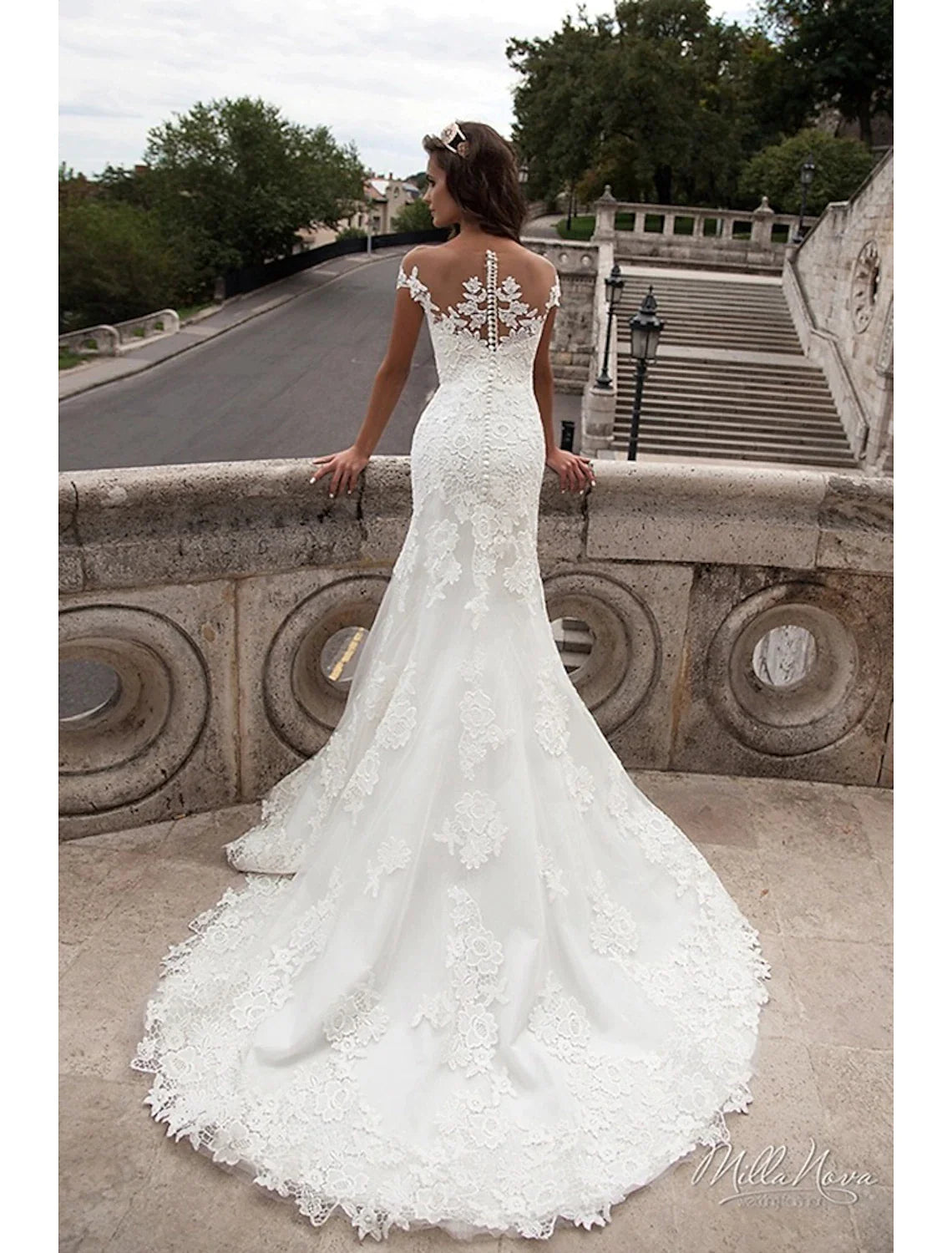 Full length view of the elegant mermaid wedding dress with cap sleeves.