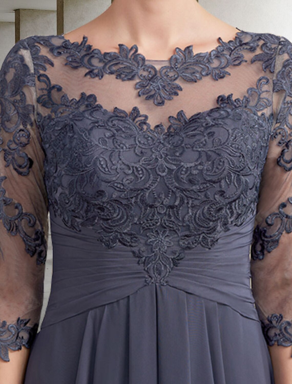 Close-up of ruched lace appliques and 3/4 sleeve on the Mother of the Bride dress.