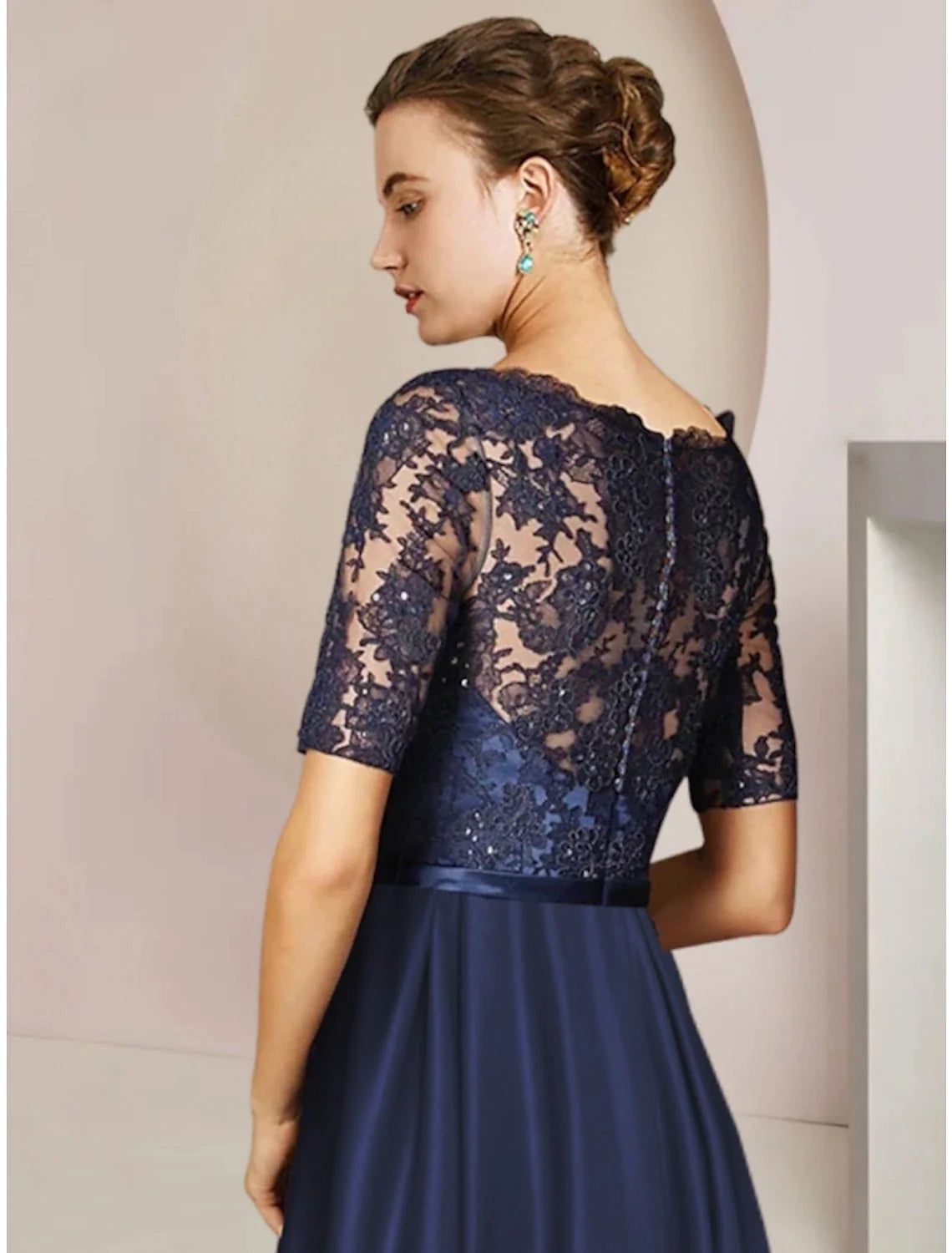 Back view of the elegant Sheath Column tea-length dress, showcasing pleats and bow details.