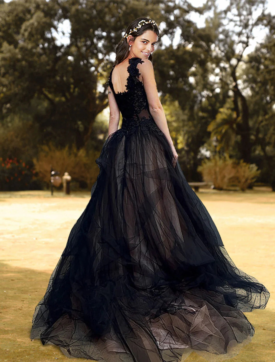 Back view of a ball gown prom dress featuring a court train and corset detailing.