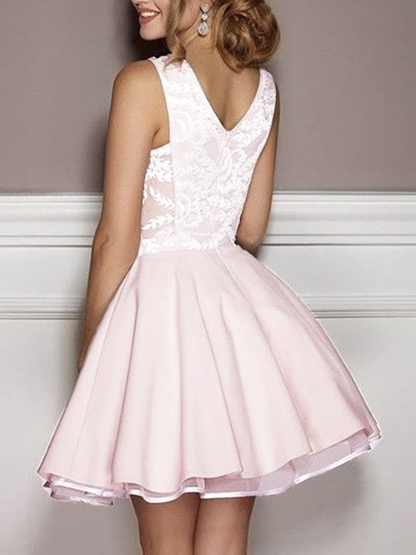 Close-up of the V-neck and applique on a satin A-Line homecoming dress.
