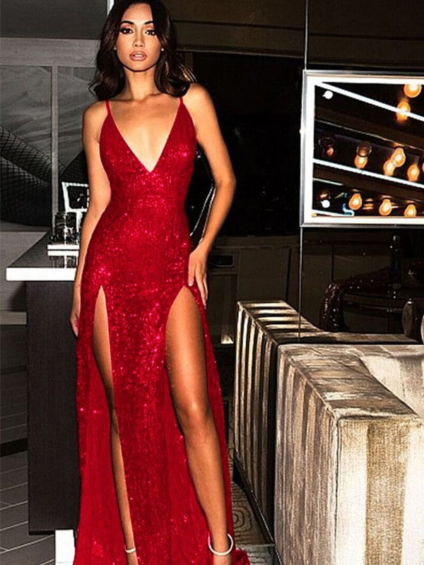 Back view of a woman in a glamorous sequined evening dress with a sweep train.