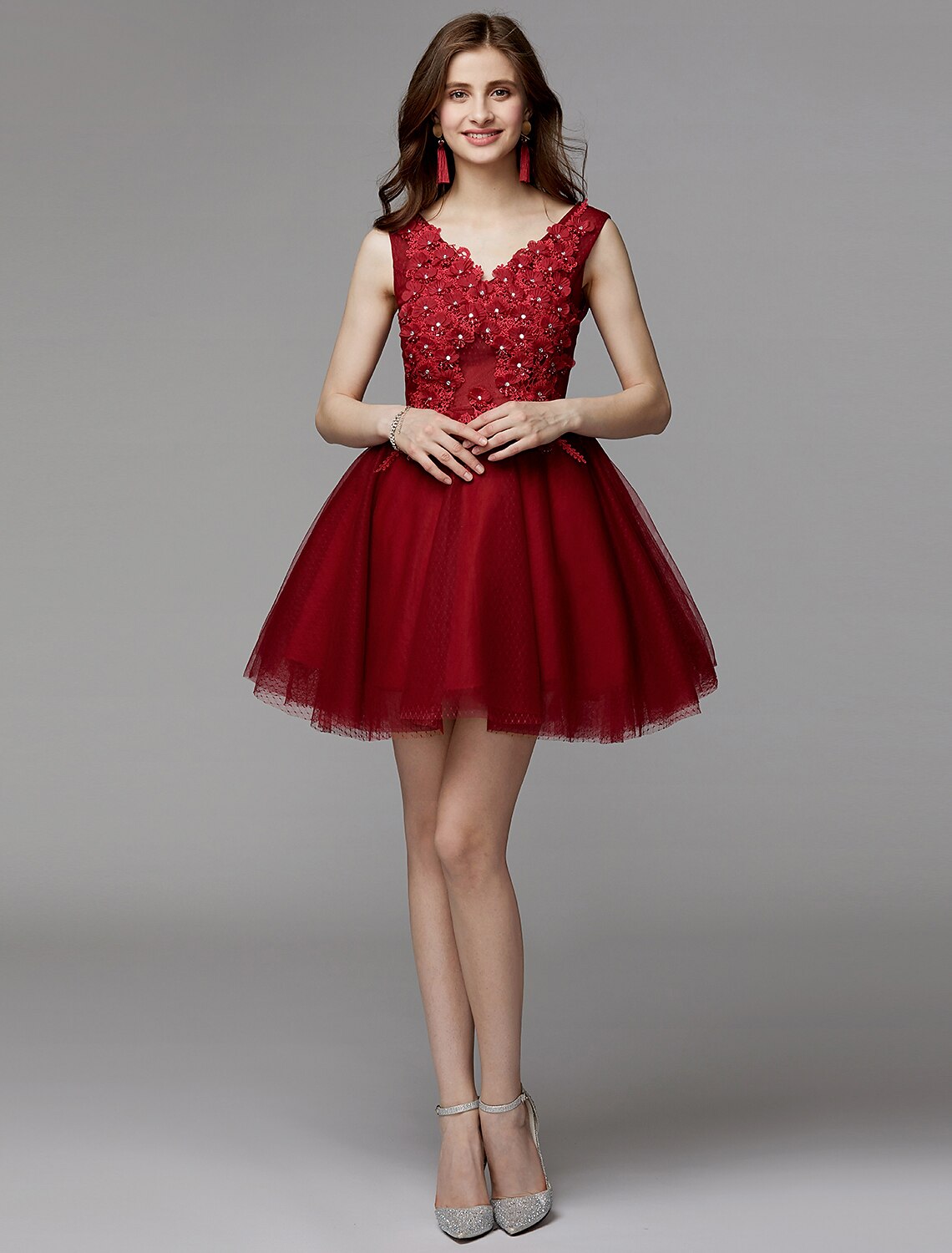 Model looking over her shoulder, displaying the back details of the short party dress.