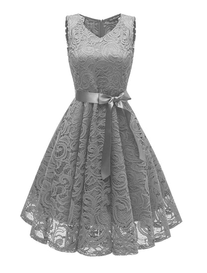 Side profile of a sleeveless cocktail dress with pleated skirt.