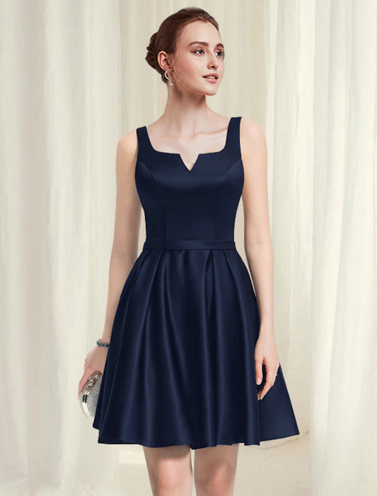 A-line little black satin cocktail dress with scoop neck and pleats.