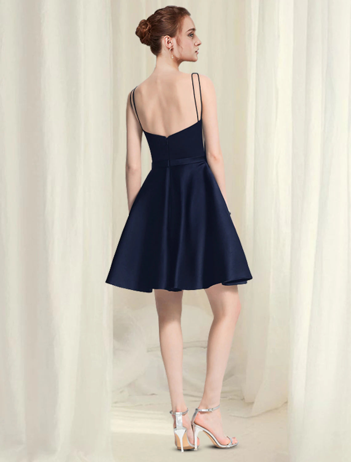 A-line little black satin homecoming dress with scoop neck and pleats.