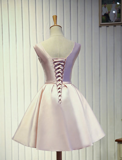 Back view of a sleeveless knee-length prom dress showing backless design.