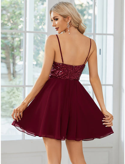 Close-up of sequin and pleat details on the A-line dress.