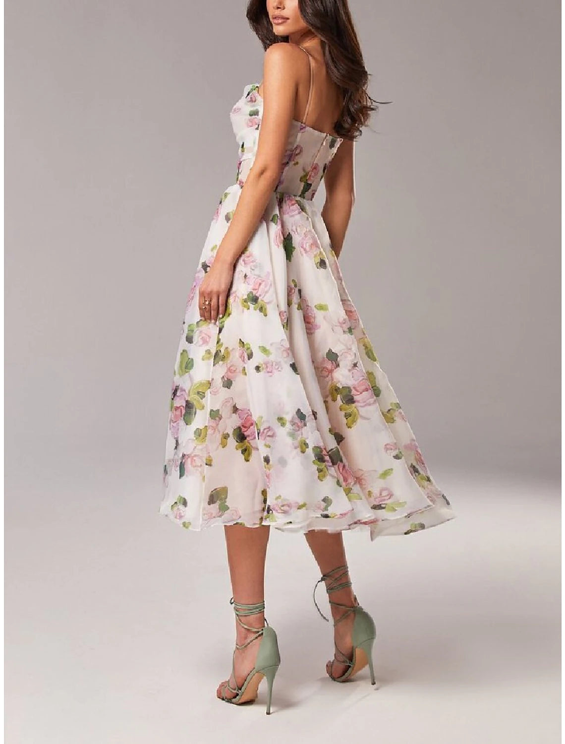 Back view of the printed A-line tea length dress on a model.