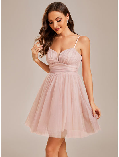 Back view of a light blue A-line short tulle dress, showing spaghetti straps and ruched detailing.