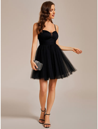 Side profile of a model in a light blue A-line short tulle cocktail dress.