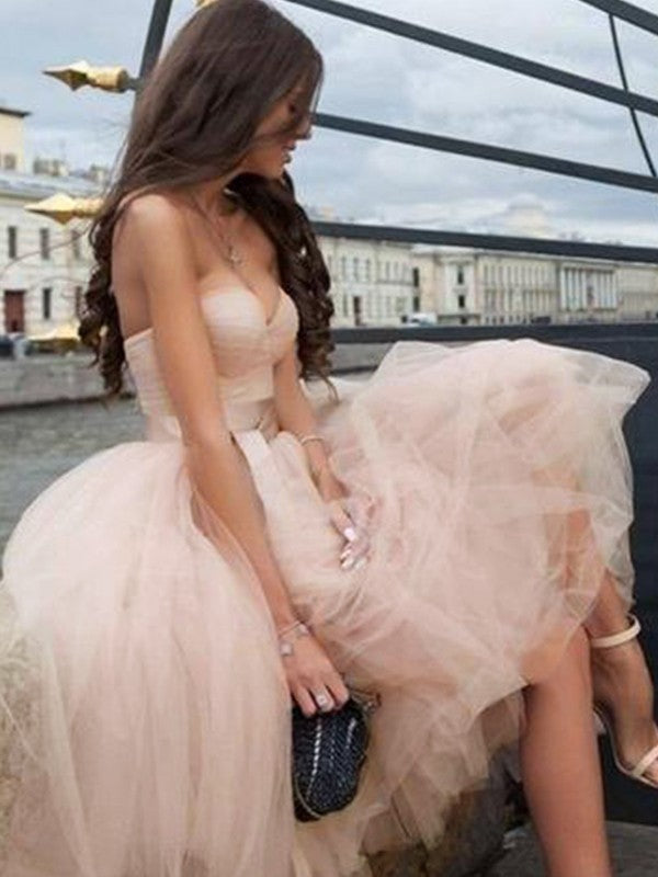 Back view of an A-Line tulle tea-length homecoming dress with a sash.