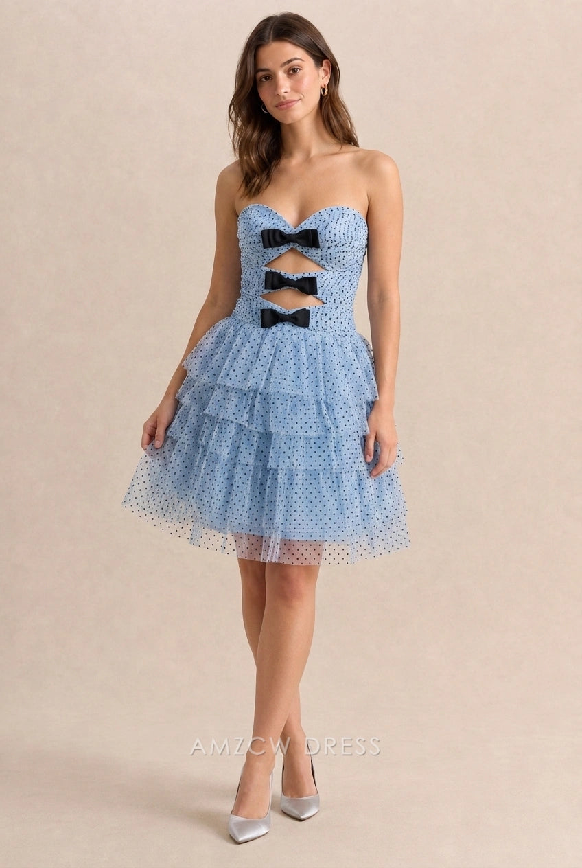 Woman in light blue polka dot A-line short homecoming dress with sweetheart neckline.
