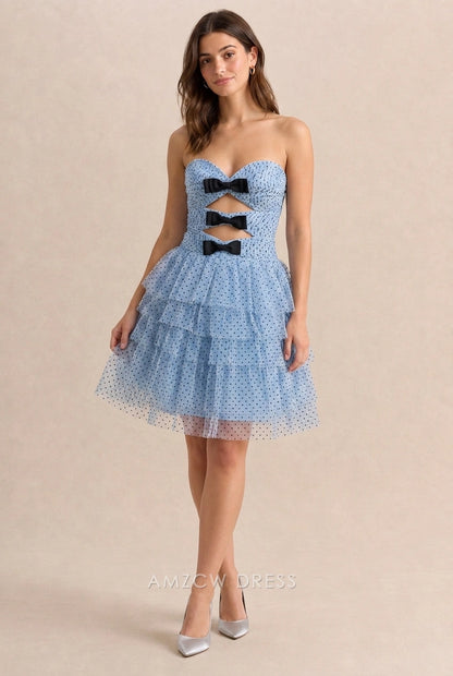 Woman in light blue polka dot A-line short homecoming dress with sweetheart neckline.