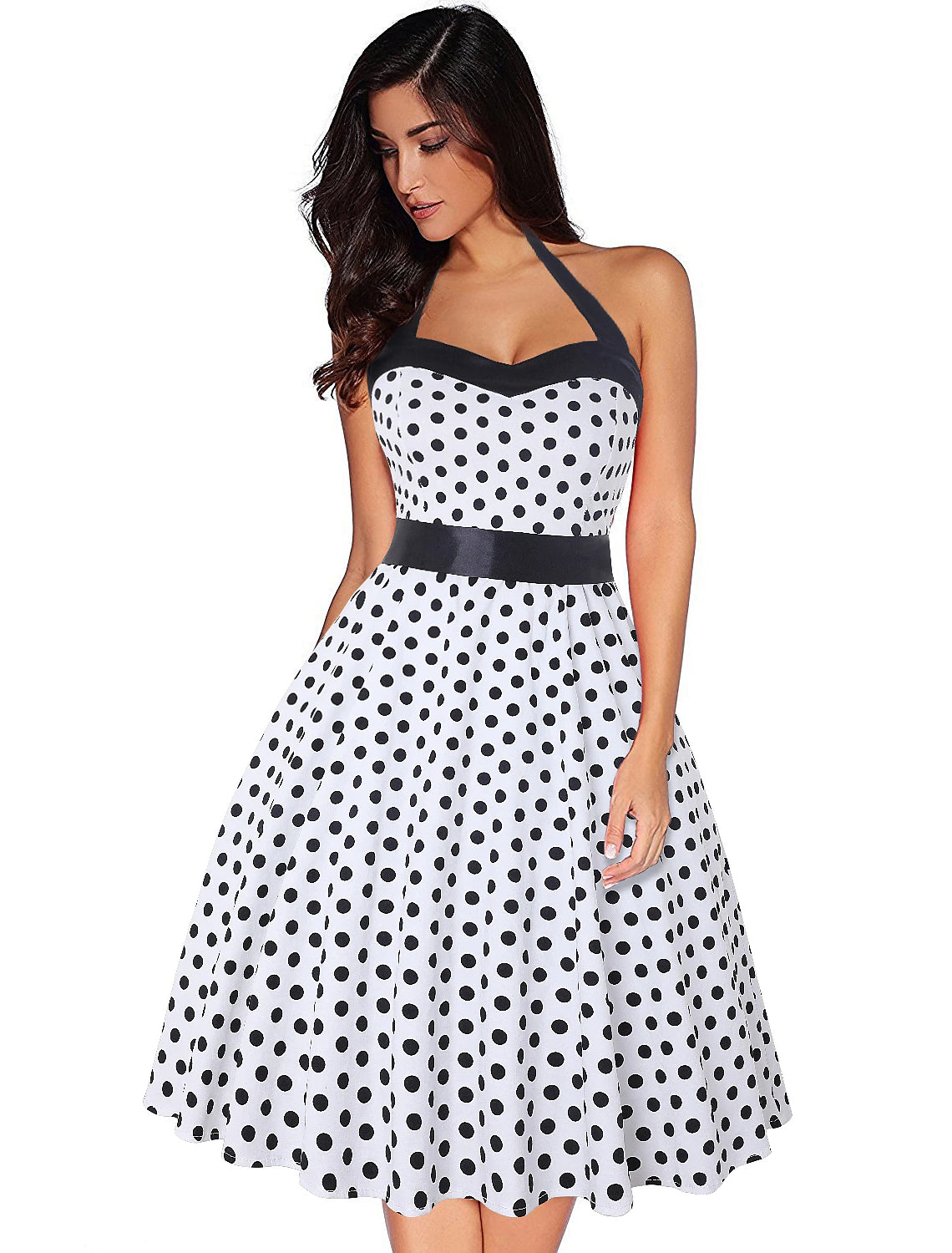 Woman wearing a red polka dot halter neck flare dress, back view.