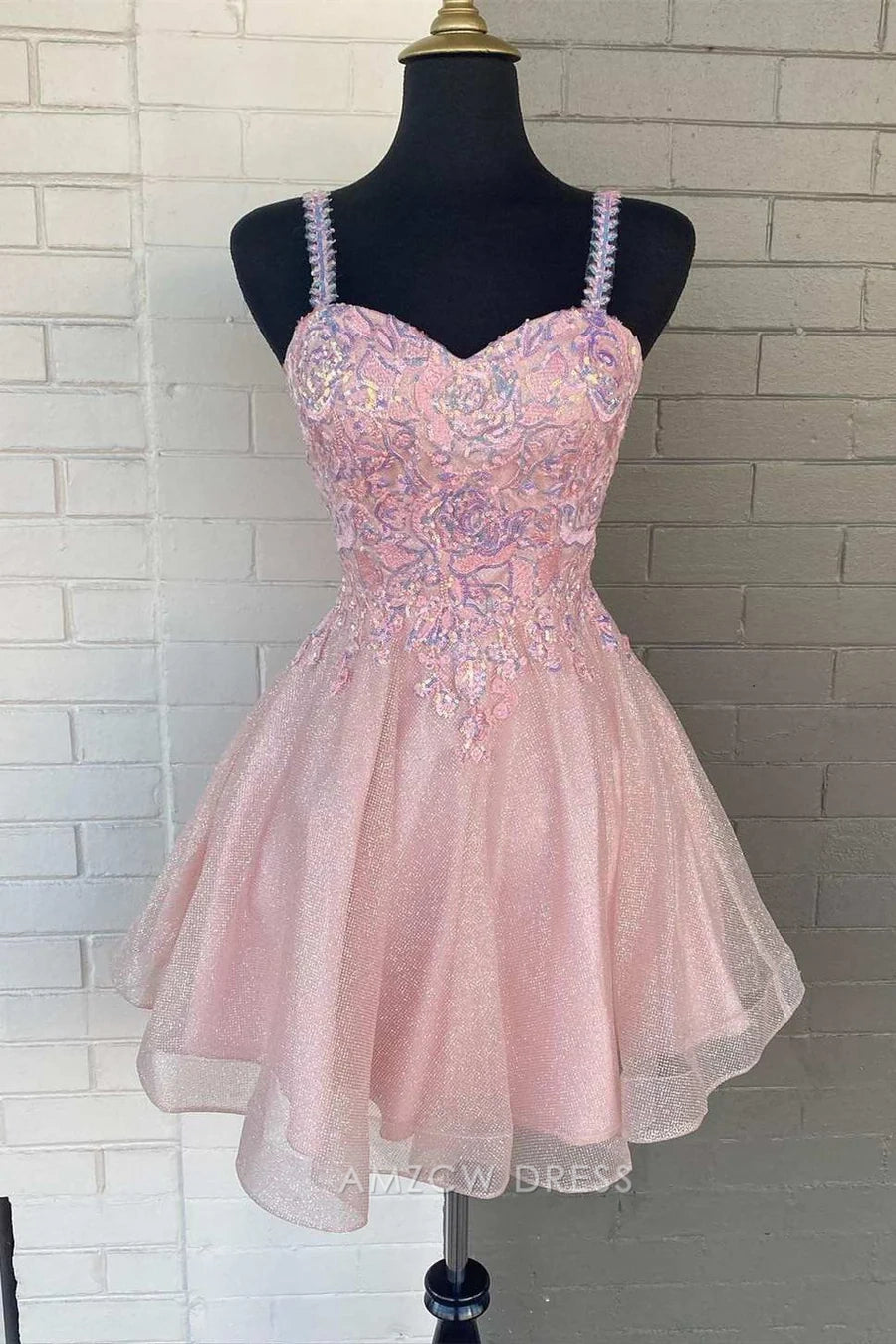 Back view of a pink sequin A-line short homecoming dress with glitter tulle skirt.