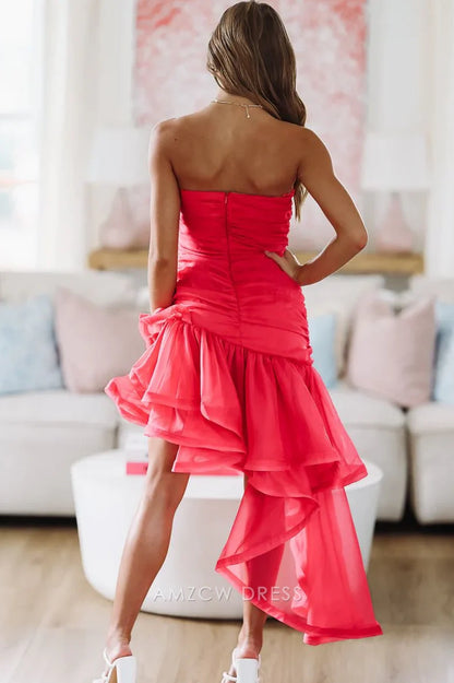 Model in a fuchsia high-low dress, showcasing the tiered ruffles and elegant silhouette.