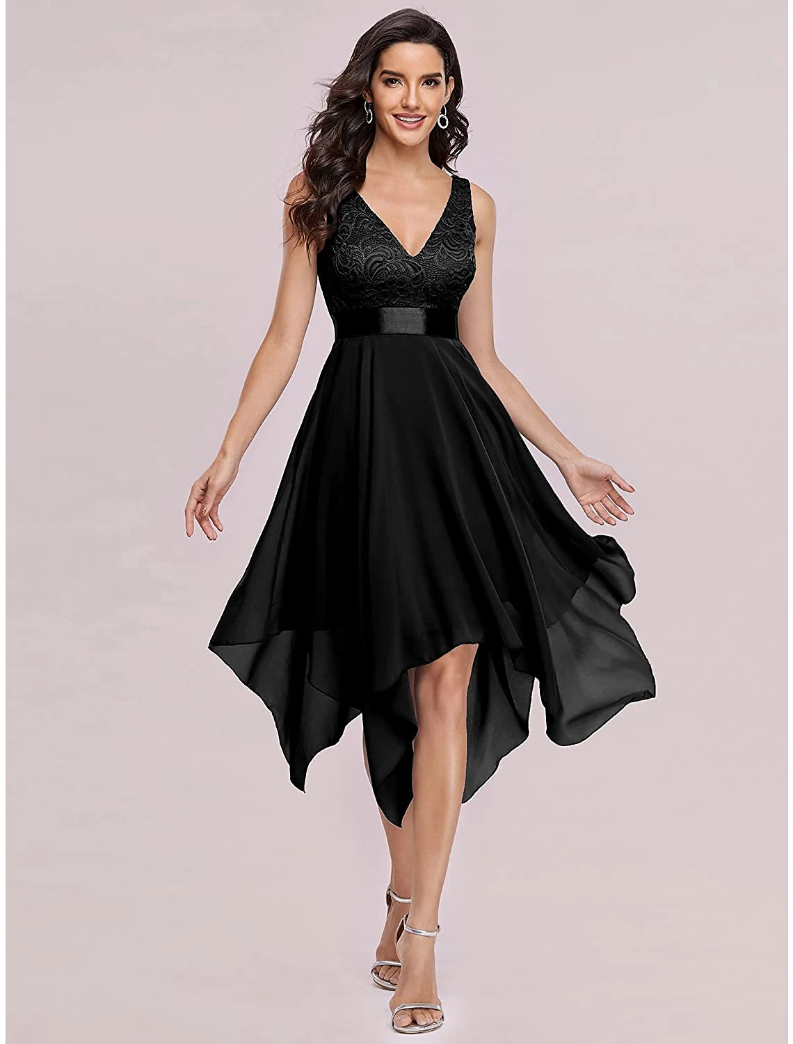 Model wearing a dark A-line chiffon cocktail dress with a V-neck and asymmetrical hem.
