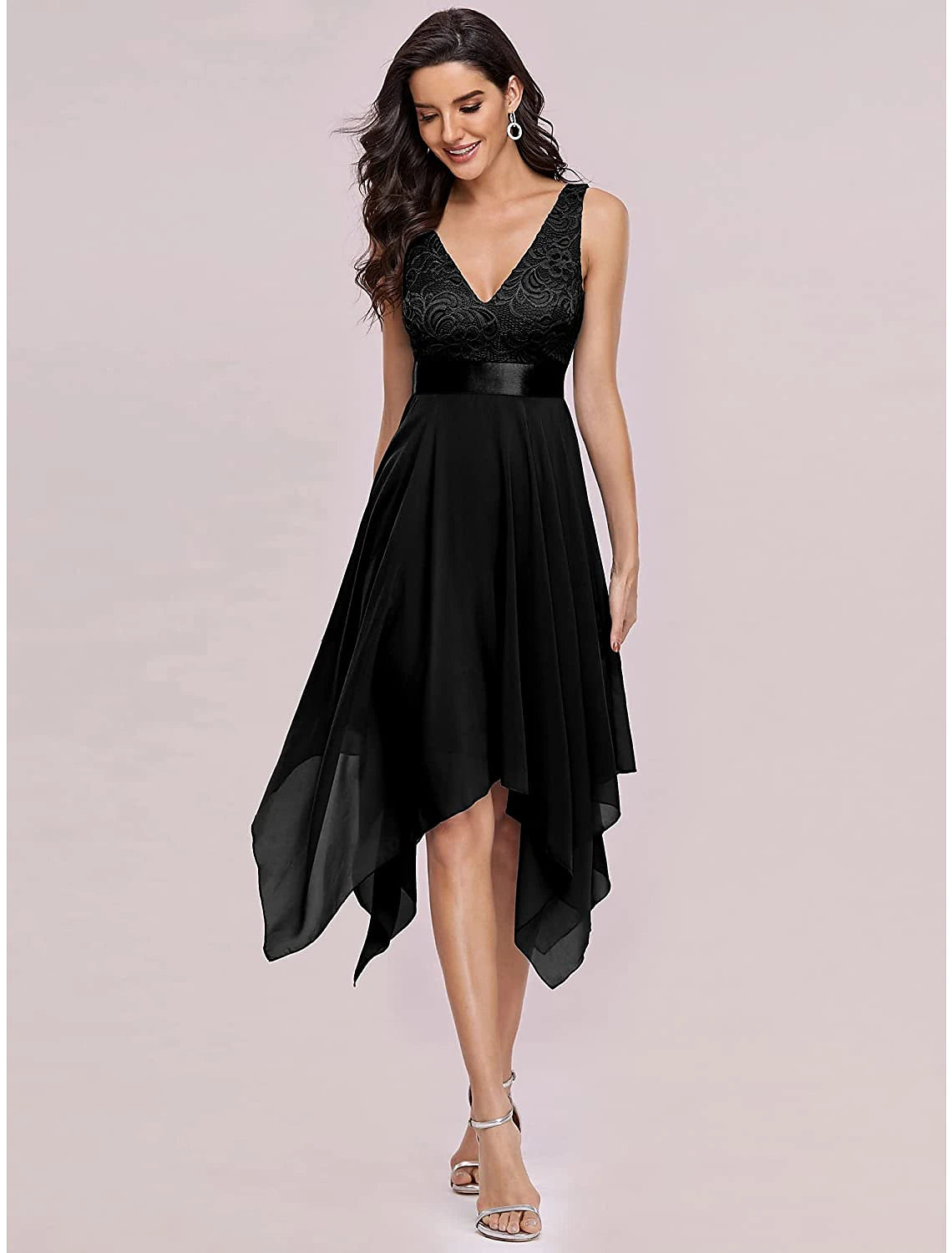Model posing in a dark A-line chiffon dress, showcasing the V-back and flowing asymmetrical skirt.