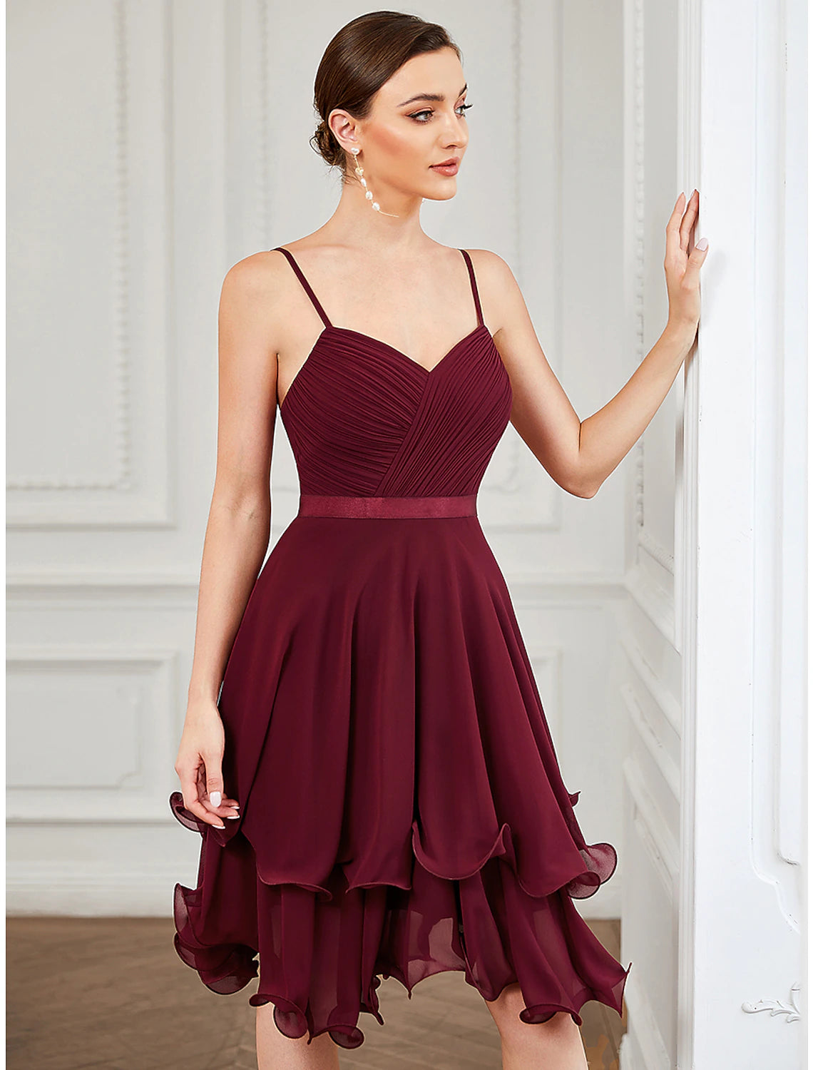 Side view of a sleeveless A-line mini dress in chiffon with tiered detailing.