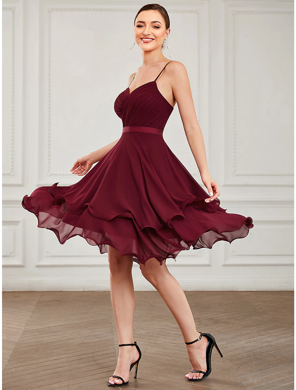 Close-up of the tiered chiffon fabric and sweetheart neckline on a short A-line dress.