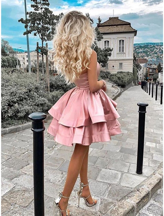 Model wearing a light-colored one-shoulder A-line satin mini dress, front view.
