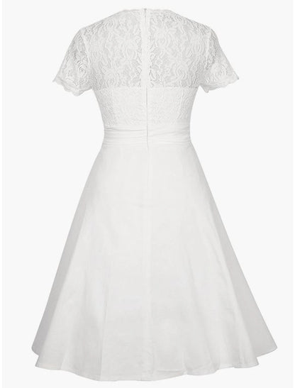 Back view of an A-line knee-length satin dress with intricate appliques.