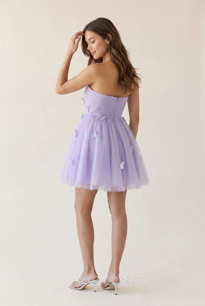 Model showcasing the open back and ruched bustier of a lavender purple strapless mini homecoming dress.