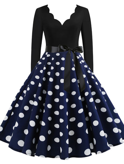 Woman wearing a blue 1950s vintage A-line midi dress with a sweetheart neckline.