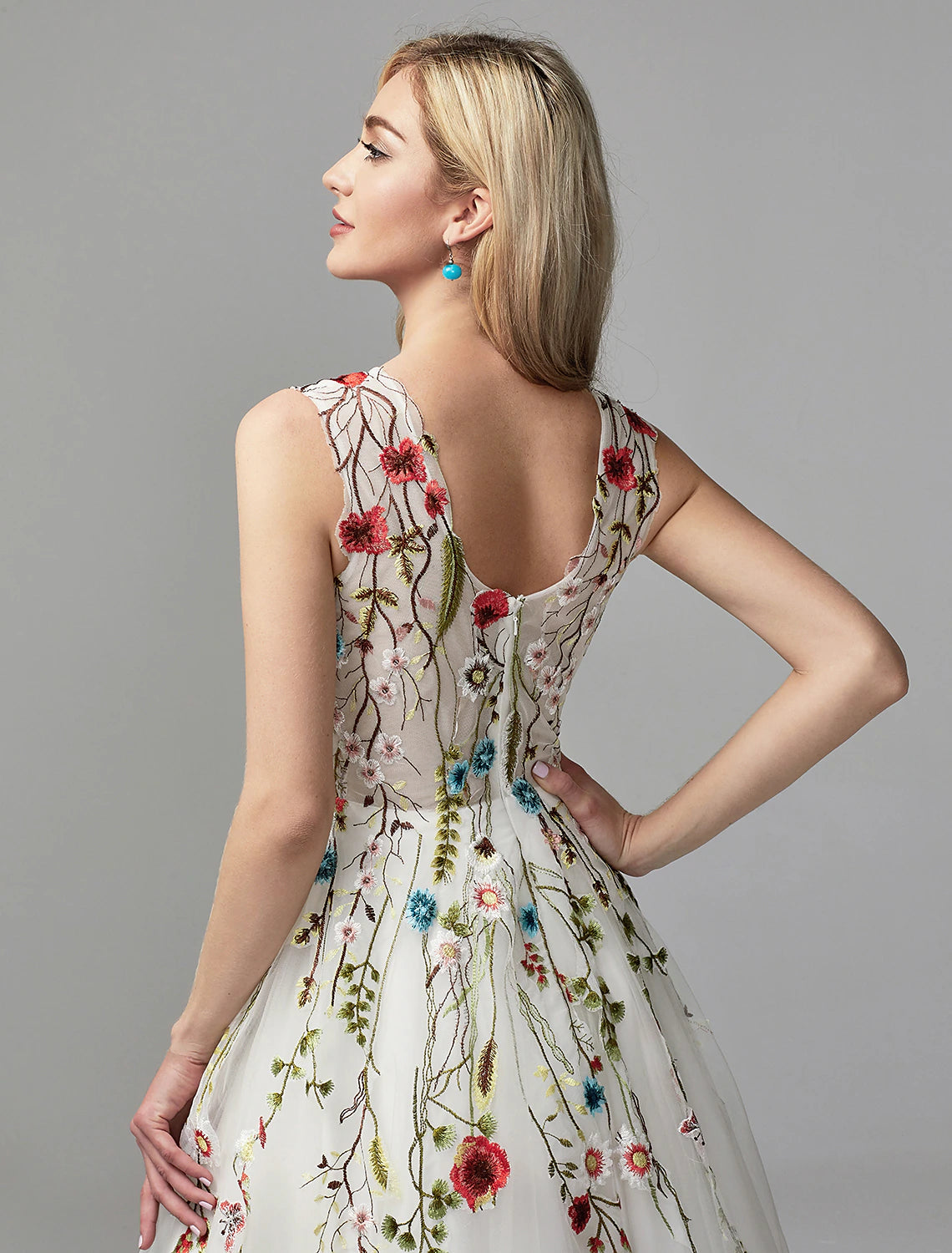Close-up of the lace and embroidery details on the floral gown.