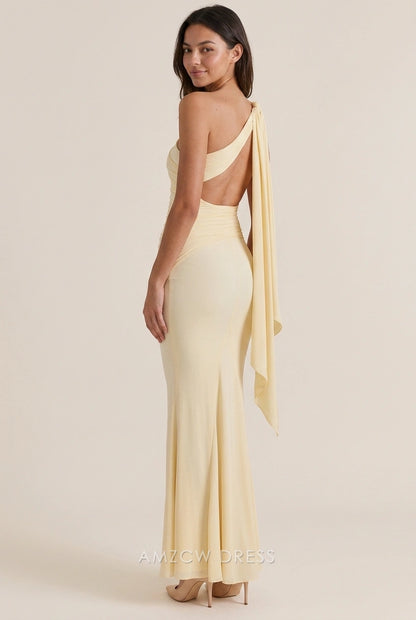 Pale yellow one-shoulder mermaid prom dress with draped detail, side view.