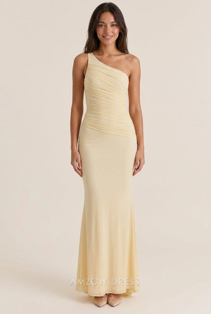 Pale yellow one-shoulder mermaid prom dress with open back design, rear view.