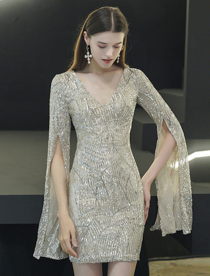Side view of the sequined mini dress, highlighting the elegant long sleeves and slit detail.
