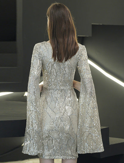 Close-up of the sparkling sequin fabric and V-neckline of the cocktail party dress.