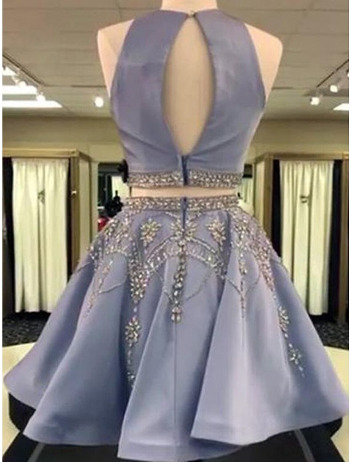 Model wearing a pink two-piece homecoming dress with a beaded jewel neck top and a satin A-line mini skirt.