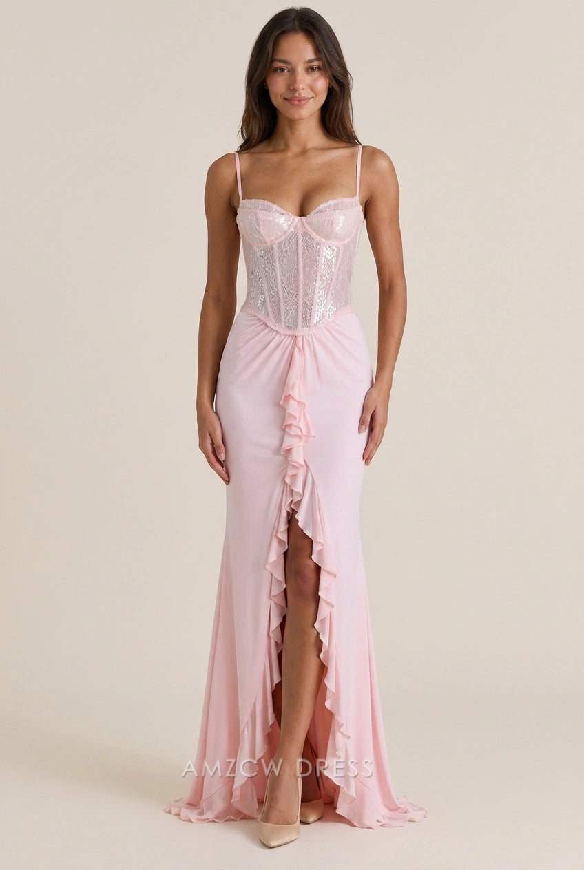 Model in a blush pink sequin mermaid prom dress with sweetheart neckline and ruffled high slit.