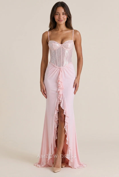 Model in a blush pink sequin mermaid prom dress with sweetheart neckline and ruffled high slit.