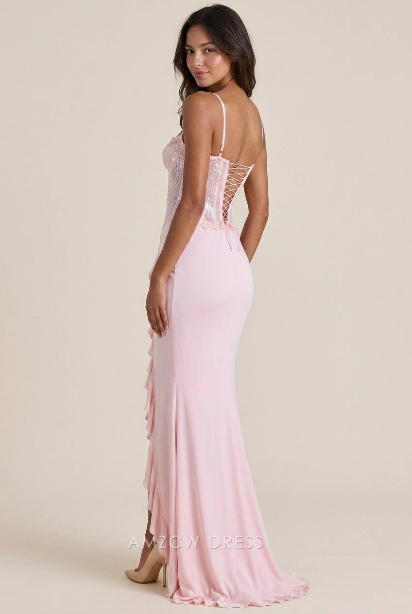 Side view of the blush pink sequin prom dress, showcasing the mermaid silhouette and ruffled slit.