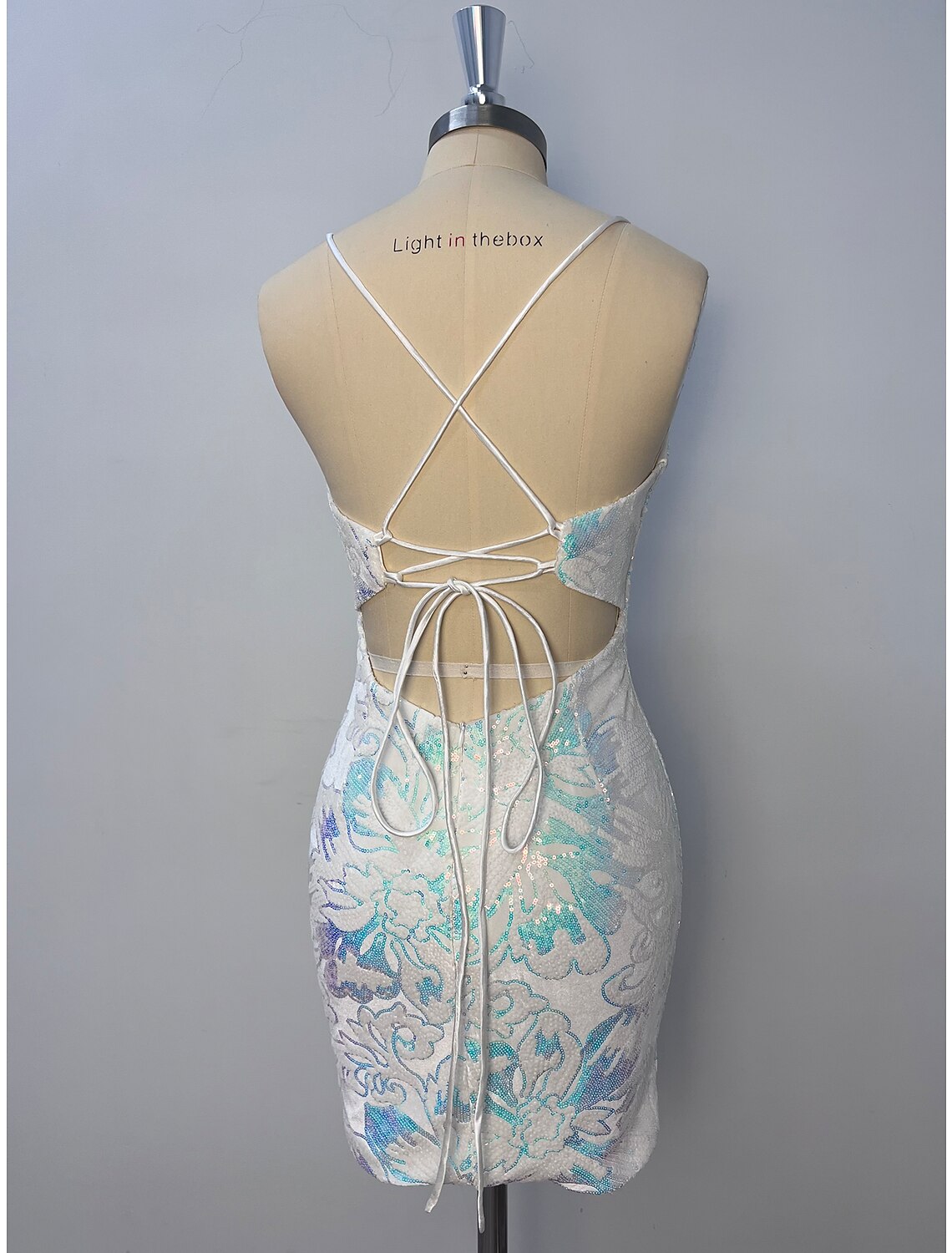 Back view of a glitter tulle floral sheath dress with spaghetti straps.