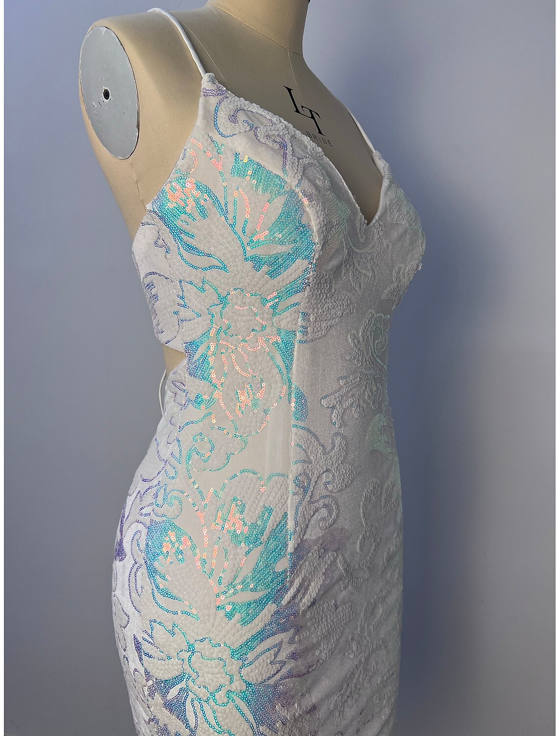 Side view of a model in a short glitter tulle floral dress.