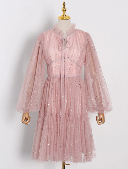 Model wearing a glittering A-line knee-length party dress with long sleeves and a high neck.