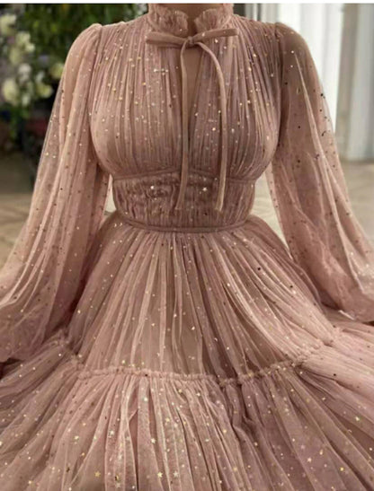 Close-up of the glittering tulle fabric and high neck detail of the A-line party dress.