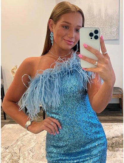 Close-up of the sequin and feather details on the one-shoulder mermaid trumpet cocktail dress.